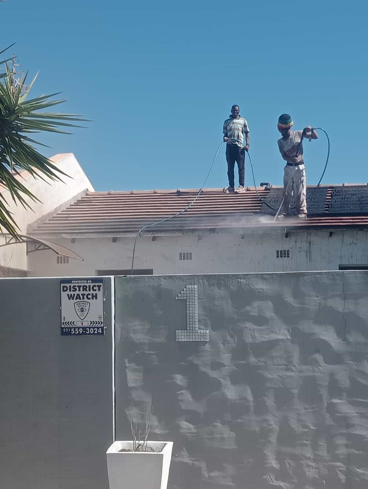 Alt Text: Professional roof painting contractor painting a tiled roof in Durbanville Cape Town Northern Suburbs